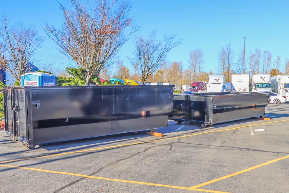 Professional dumpster rental service with roll-off container on residential driveway in Lawrenceville